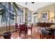 Bright dining area with wood floors, large windows offering city views, and seating for four at 57 Forsyth St # 13D, Atlanta, GA 30303