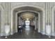 Hallway featuring arched doorways, marble floors, and ample light in an office setting at 57 Forsyth St # 13D, Atlanta, GA 30303