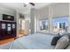 Spacious main bedroom showcasing city views from large windows and hardwood flooring at 57 Forsyth St # 13D, Atlanta, GA 30303