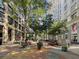 A scenic outdoor plaza with decorative pavement, trees, benches, and surrounding buildings at 57 Forsyth St # 13D, Atlanta, GA 30303