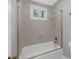 Shower and tub in the bathroom featuring textured walls and bright natural light at 747 Houston Mill Ne Rd # 1, Atlanta, GA 30329