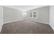 Spacious bedroom with plush carpeting, neutral paint and a large window overlooking trees at 747 Houston Mill Ne Rd # 1, Atlanta, GA 30329