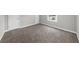 A well lit bedroom with neutral gray walls, plush carpet, and a large window at 747 Houston Mill Ne Rd # 1, Atlanta, GA 30329