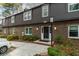 Charming brick townhouse featuring a black front door and a well-maintained front yard at 747 Houston Mill Ne Rd # 1, Atlanta, GA 30329