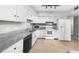 Well-lit kitchen with white cabinets, granite countertops, tile flooring, and modern appliances at 747 Houston Mill Ne Rd # 1, Atlanta, GA 30329