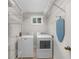 Bright laundry room with washer, dryer, and wire shelving for organization at 747 Houston Mill Ne Rd # 1, Atlanta, GA 30329