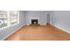 Spacious living room featuring hardwood floors, a cozy fireplace, and natural light from the window at 747 Houston Mill Ne Rd # 1, Atlanta, GA 30329