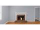 Living room featuring a brick fireplace, hardwood floors, and freshly painted walls at 747 Houston Mill Ne Rd # 1, Atlanta, GA 30329