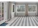 Sunroom with large windows offering natural light, neutral paint and gray and white striped rug at 747 Houston Mill Ne Rd # 1, Atlanta, GA 30329