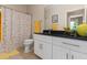 Well-lit bathroom with a dark countertop, white cabinets, and a shower with a floral-patterned curtain at 10 Perimeter Summit Ne Blvd # 2112, Atlanta, GA 30319