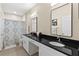 Bathroom featuring a double vanity, framed mirrors, black granite countertops, and a shower with decorative curtains at 10 Perimeter Summit Ne Blvd # 2112, Atlanta, GA 30319