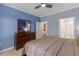 A bedroom painted blue, featuring a large bed, nightstands, and access to the bathroom at 10 Perimeter Summit Ne Blvd # 2112, Atlanta, GA 30319
