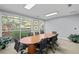 Conference room featuring an oval wooden table, comfortable seating, and natural light from large windows at 10 Perimeter Summit Ne Blvd # 2112, Atlanta, GA 30319