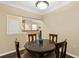 Comfortable dining area with a dark wood table and seating for four at 10 Perimeter Summit Ne Blvd # 2112, Atlanta, GA 30319