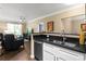 Modern kitchen featuring stainless steel sink, dark granite counters and breakfast bar overlooking living area at 10 Perimeter Summit Ne Blvd # 2112, Atlanta, GA 30319