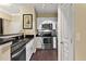 Well-lit kitchen features stainless steel appliances, white cabinets, and a dark countertop with modern fixtures at 10 Perimeter Summit Ne Blvd # 2112, Atlanta, GA 30319