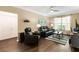 Living room with a ceiling fan, dark wood floors and a leather sofa at 10 Perimeter Summit Ne Blvd # 2112, Atlanta, GA 30319