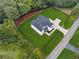 Aerial view highlighting the home's generous lot size, lush lawn, and private wooded surroundings at 3165 Hall Rd, Dacula, GA 30019