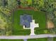 Aerial view of the house, fenced in lawn, and a driveway leading from a quiet road at 3165 Hall Rd, Dacula, GA 30019