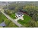 An aerial view of a modern two-story home with a large lot, black fence, and mature trees at 3165 Hall Rd, Dacula, GA 30019