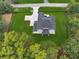 Aerial view of the property showcasing the expansive lawn, modern house design, and surrounding trees at 3165 Hall Rd, Dacula, GA 30019