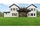Expansive backyard featuring a covered patio with a ceiling fan and large lawn at 3165 Hall Rd, Dacula, GA 30019