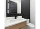 Modern powder bath with a dark accent wall, sleek fixtures and vanity at 3165 Hall Rd, Dacula, GA 30019