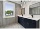 Modern bathroom with dual vanity, quartz countertops, dark blue cabinets, and contemporary fixtures at 3165 Hall Rd, Dacula, GA 30019
