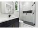 Modern bathroom featuring sleek vanity, framed mirror, and a glass-enclosed shower with rainfall shower head at 3165 Hall Rd, Dacula, GA 30019