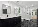 Elegant bathroom with double vanity, framed mirrors, and a modern glass-enclosed shower, exuding luxury at 3165 Hall Rd, Dacula, GA 30019