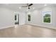 Bright bedroom with large windows offering a serene view, complemented by a modern ceiling fan at 3165 Hall Rd, Dacula, GA 30019