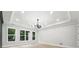 Bright room with tray ceiling and windows showcasing backyard trees at 3165 Hall Rd, Dacula, GA 30019