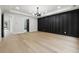 Spacious room features stylish accent wall and modern lighting, adjacent to entry and bath at 3165 Hall Rd, Dacula, GA 30019