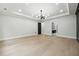 Large room with tray ceiling, modern lighting and doorway to the adjacent bath at 3165 Hall Rd, Dacula, GA 30019
