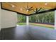 Chic covered patio boasts a ceiling fan, wood ceiling, black marble tile, and backyard views at 3165 Hall Rd, Dacula, GA 30019