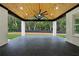 Stylish covered patio with black marble flooring, wood ceiling, and fan overlooking backyard at 3165 Hall Rd, Dacula, GA 30019