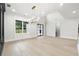 Bright dining room featuring natural light, modern chandelier, and light wood floors at 3165 Hall Rd, Dacula, GA 30019