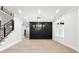 An elegant dining room with hardwood floors, modern lighting, and an accent wall at 3165 Hall Rd, Dacula, GA 30019