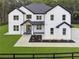 A beautiful two-story white brick home featuring black trim, black roof and lush landscaping at 3165 Hall Rd, Dacula, GA 30019