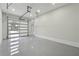 Clean three-car garage with an epoxy floor and translucent door that lets in natural light at 3165 Hall Rd, Dacula, GA 30019