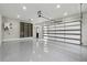 Spacious three-car garage with epoxy floors and organized shelving for efficient storage and easy maintenance at 3165 Hall Rd, Dacula, GA 30019
