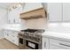Close-up of a gourmet kitchen with a stainless steel range, custom cabinetry, and stylish backsplash at 3165 Hall Rd, Dacula, GA 30019