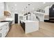 Gourmet kitchen with stainless steel appliances, large center island and modern lighting at 3165 Hall Rd, Dacula, GA 30019