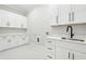 Well-organized laundry room with plenty of storage space and a sink for added convenience at 3165 Hall Rd, Dacula, GA 30019