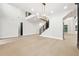 Bright living room features an elegant chandelier, staircase and beautiful light wood floors at 3165 Hall Rd, Dacula, GA 30019
