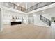 Open-concept living space featuring light hardwood floors, staircase and chef's kitchen at 3165 Hall Rd, Dacula, GA 30019