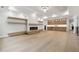 Spacious living room with fireplace, floating shelves, wet bar, hardwood flooring and recessed lighting at 3165 Hall Rd, Dacula, GA 30019
