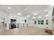 Open-concept living room featuring modern light fixture, fireplace and black iron railings at 3165 Hall Rd, Dacula, GA 30019
