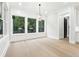 Bright sunroom featuring large windows that flood the space with natural light and offer views of the backyard at 3165 Hall Rd, Dacula, GA 30019