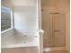 Bright bathroom featuring a soaking tub, a separate shower with glass door and natural light at 40 Zebulon Pl, Covington, GA 30016